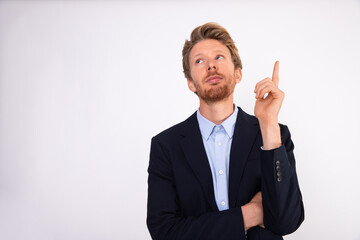Portrait of pensive young businessman making idea gesture. Caucasian manager wearing blue shirt and black suit coat having inspiration. Idea and creativity concept
