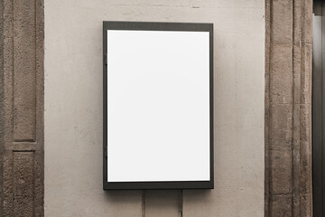 White blank metal frame with mock up place mounted on concrete wall at urban street