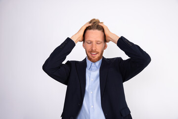 Portrait of smiling businessman forgetting something. Young Caucasian manager wearing blue shirt and black suit coat clutching his head or touching hair. Problem and trouble concept