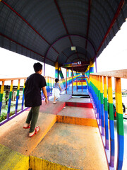 perlis, Malaysia - Aug 6, 2022: Rainbow bridge in Kuala Perlis. People walking crossing