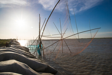 Traditional Fishing net Vessel 
 in padma river under the open blue sky