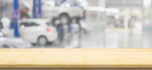 Empty wood table top with car service centre auto repair workshop blurred background