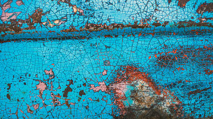 Enamelled colorful cracked and peeling surface of old motorcycle. Rusty metal surface with blue...