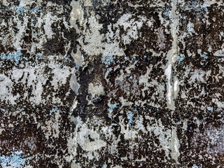 Dirty old eroded cracked plaster cement block fence. Concrete block wall. Destroyed crumbling cement mortar texture. Background of wall. Brick texture with scratches and cracks. brick wall background