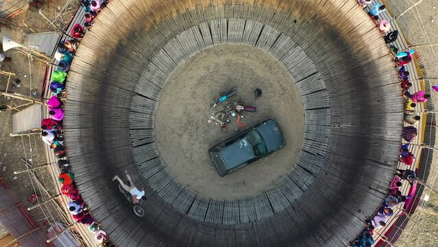 Daredevil motorcyclists ride around a steep 'wall of death'
