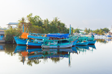 Fototapeta na wymiar Colorful traditional squid fishing boats on calm water of Duong Dong river in Phu Quoc island, Vietnam