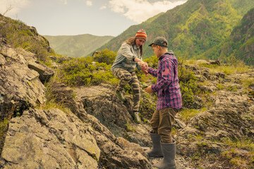 Fototapeta na wymiar boy and adult woman hiking in the mountains 