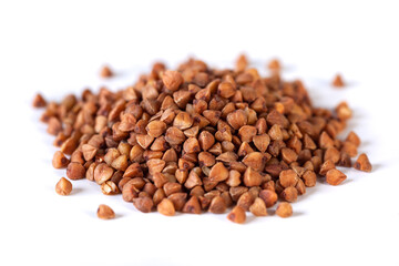 Pile of buckwheat seeds isolated on white background, closeup