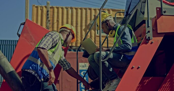 team of African-American container workers use their laptops to inspect shipping containers. Wear a hardhat to be safe at work. professional collaboration. transportation of goods