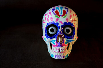 mexican painted skull in day of the Dead with black background