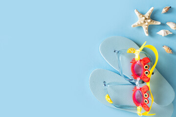 Summer holidays flat lay with shells, starfish and accessories on blue background