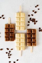 Coffee popsicle ice cream dessert with coffee beans on white background