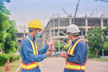 Asian engineer construction team checking work for control and management in the construction site or building site