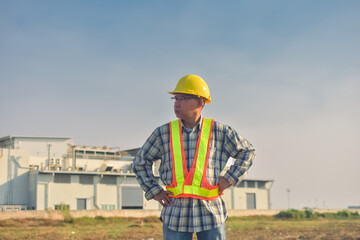 Senior Engineer Asian man working with tablet technology construction, construction worker with tablet computer and wearing construction uniform