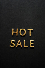 Fototapeta na wymiar Hot sale - golden words on black. Online sale or clearance store concept.