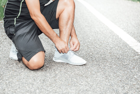 Man Are Tying Sneakers. Get Ready For Jogging On The Road In The Park, Concept To Fat People Exercise For Good Health Care.