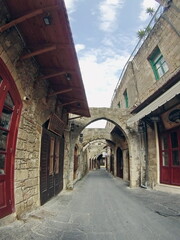 Fototapeta na wymiar Arches over a cobblestone street on the island of Rhodes, Greece