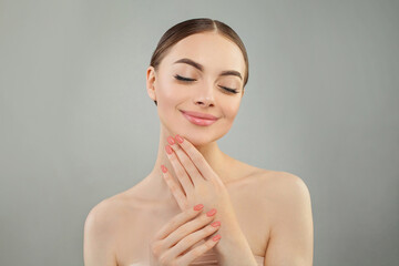 Beautiful model woman showing perfect hands with manicure and smiling