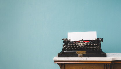 Old vintage typewriter on a table over an isolated background. - Powered by Adobe