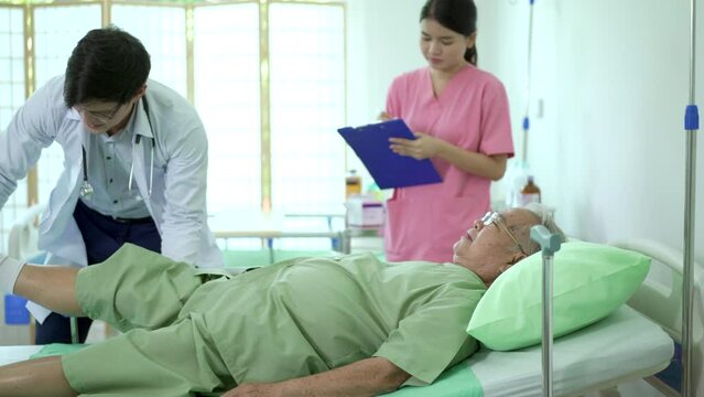 Asian old man taking or consulting with a professional physical therapist.