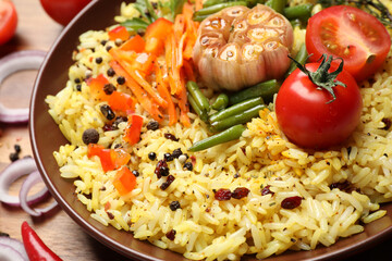 Tasty rice pilaf with vegetables on table, closeup