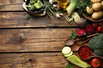 Flat lay composition with fresh products on wooden table, space for text. Healthy cooking