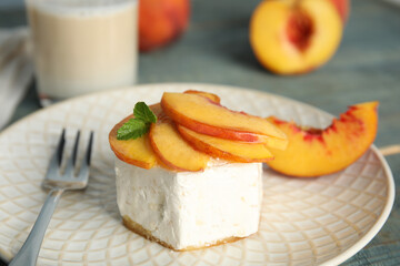 Delicious dessert with peach slices on plate, closeup