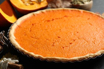 Delicious homemade pumpkin pie on black table, closeup