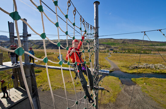 boy playing at high rope access course in Iceland