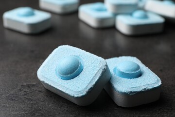 Water softener tablets on grey table, closeup