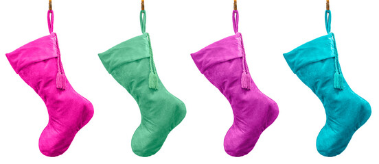Pastel plush velvet Christmas stockings hanging from brass hooks