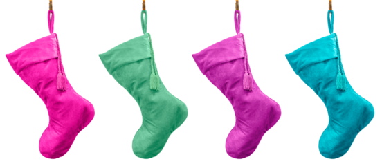 Pastel plush velvet Christmas stockings hanging from brass hooks