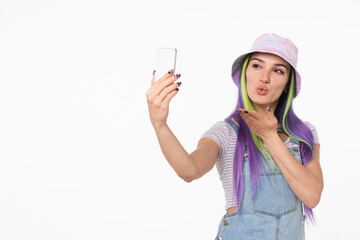 Beautiful caucasian young hipster teenage girl woman taking selfie having videocall online, vlogging blogging, sending air kiss isolated in white background - obrazy, fototapety, plakaty