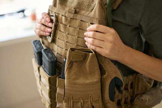 Woman is wearing a protective body armor and hiking kit