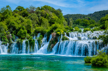 Sun breaks through to render blue water at the cascades of Krka National Park