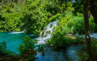 Fototapeta na wymiar Turquoise water pool at the bottom of the falls