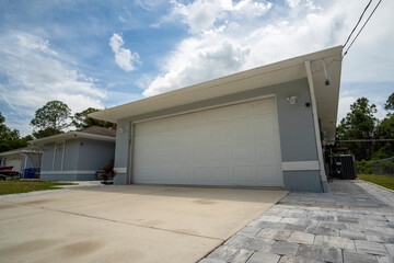 Wide garage double door and concrete driveway of new modern american house