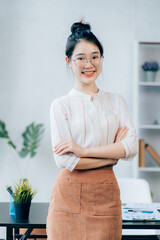 Portrait of beautiful Asian businesswoman manager with a smile standing holding document at the office