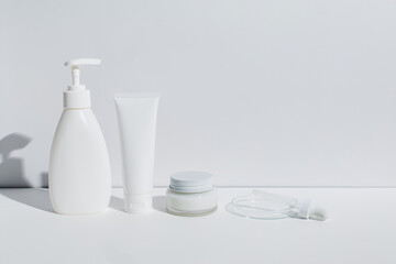 Petri dishes and bottles with cosmetics on white background. Natural medicine, cosmetic research, bio science, organic skin care products. Copy space. Dermatology