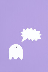 Trendy minimalist halloween design, white cute ghost with a shouting blank speech bubble on lilac background, pastel color composition with copy space.