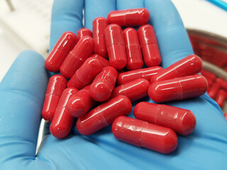 Making red capsules in the pharmacy laboratory.