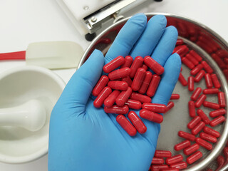 Making red capsules in the pharmacy laboratory.