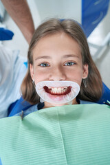Young patient with dental mouth opener before medical examination