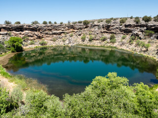 Fototapeta na wymiar View of Montezuma Well with cliff dwellings visible in the upper left corner - Arizona, USA