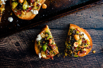 Caramelized Brussels Sprout Toast with Burrata and Bacon: Overhead view of toasted bread topped...