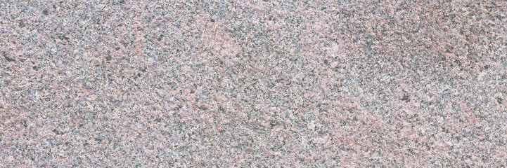 Granite texture. Natural pink granite with a grainy pattern. Stone background. Solid rough surface of rock. Durable construction and decoration material. Close-up.