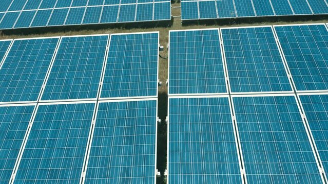 Solar panels in rows, slow aerial movement. Solar battery farm, sustainable energy, ecology