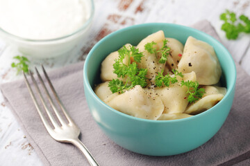 Russian national dish pelmeni served in a plate	