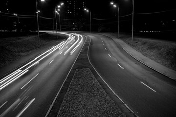 Fototapeta na wymiar Light trails from cars passing on the road