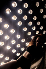 Sexy girl dance on front of spot light wall with smoke